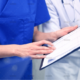 demo-attachment-1392-close-up-of-doctors-with-clipboard-at-hospital-PNAWFWS